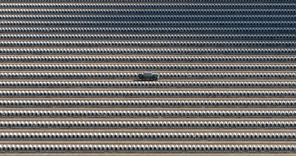 Drone footage of a milk dispenser truck driving amid thousands of calf hutches at a massive dairy farm in Arizona.