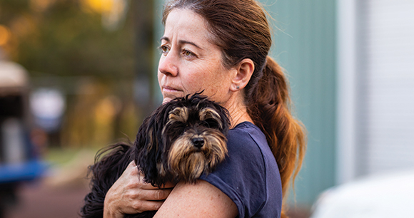 Woman holding her pet dog.