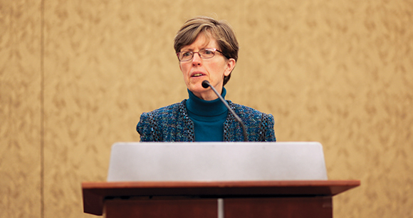 AWI’s Nancy Blaney speaking at a podium.